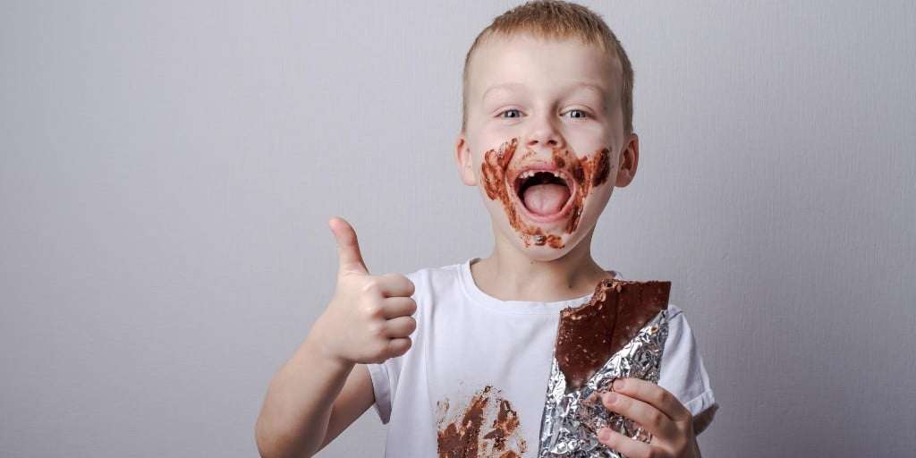 happy kid covered in chocolate happy kid covered in chocolate